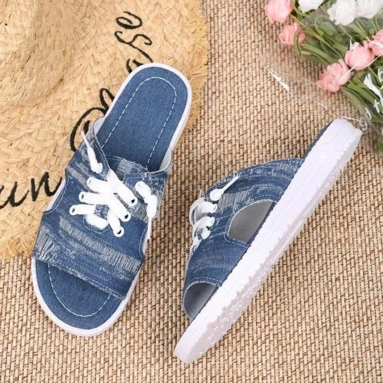Blue women's Roman style flat canvas slippers with a rubber sole.