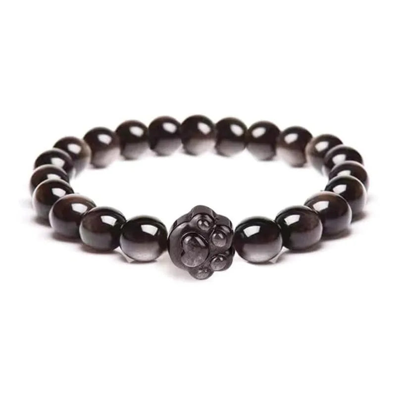 Handmade natural stone bead bracelet with silver cat pendant on neutral background