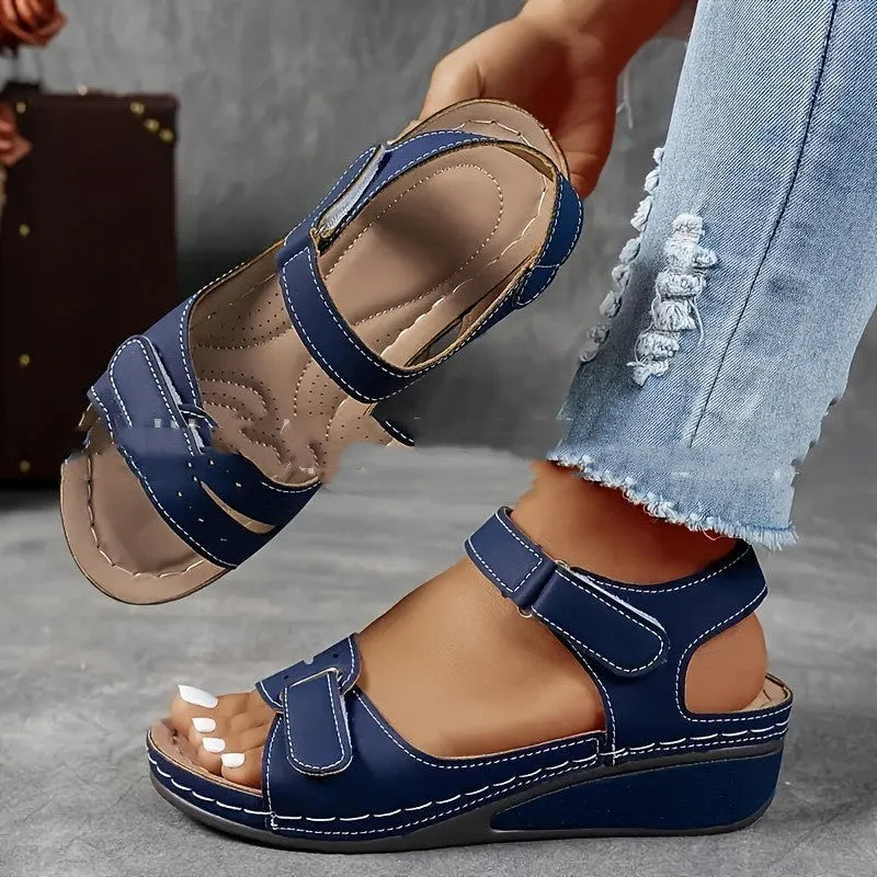 Women's beige thick-bottom strap sandals showing the Velcro fastener and round toe design.