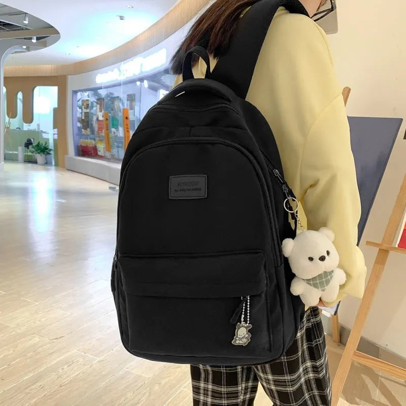 Large capacity nylon backpack for women, waterproof and wear-resistant, in solid colour with zips and straps