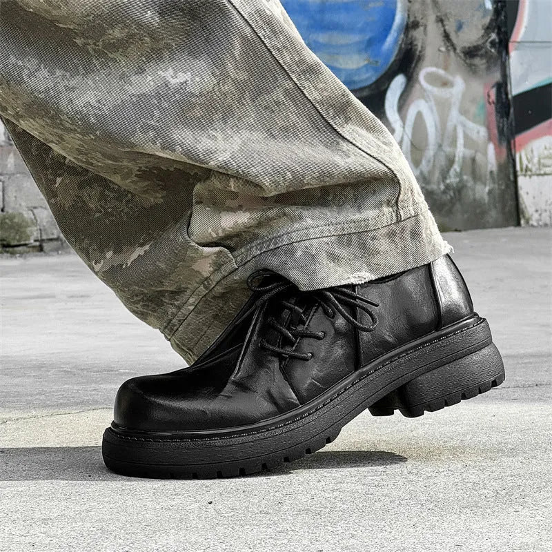 Black platform warped head leather shoes with a low top microfiber upper and rubber sole.