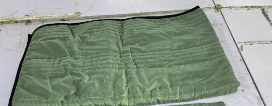 Lightweight seersucker summer quilt in various colours on a bed