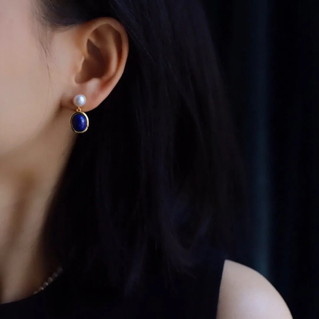A pair of lapis lazuli pearl drop earrings on 925 silver posts with engraved patterns.