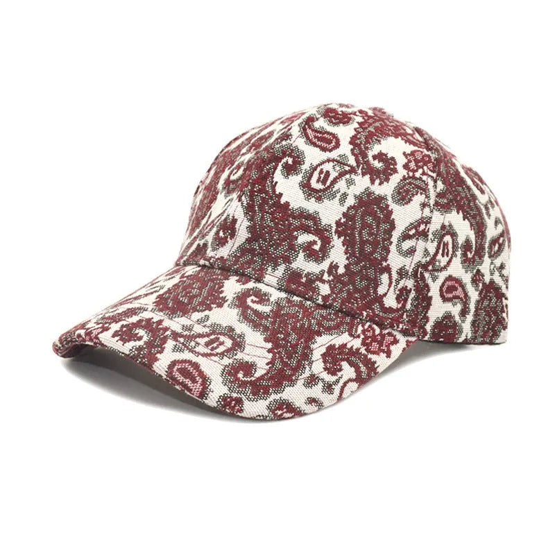 Blue paisley print polyester baseball cap with a dome crown, shown from the side.