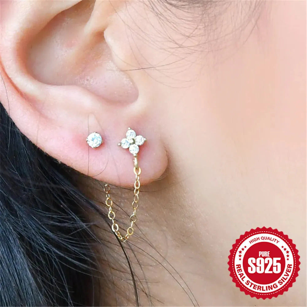 S925 sterling silver ear stud with geometric diamond flower, tassel, and chain design in a gold colour.