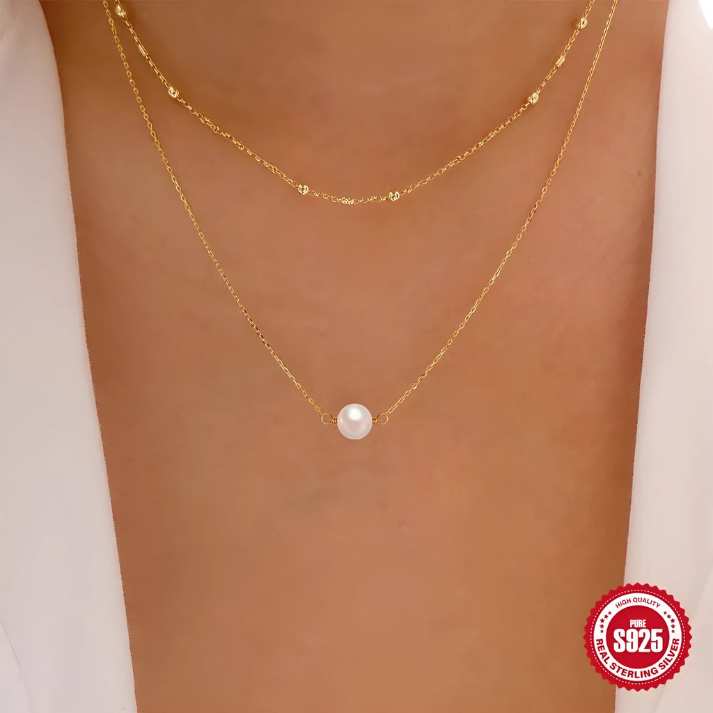 Sterling silver geometric pendant necklace with two pearls, on a ball bead chain, shown in gold and white gold plating.