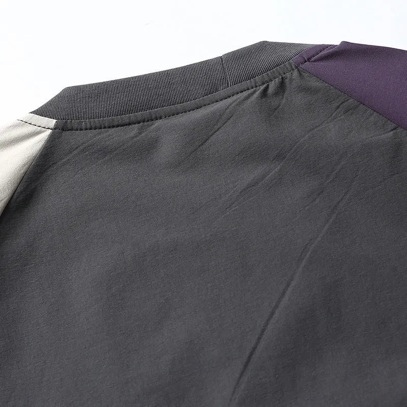 Dark grey men's loose-fit T-shirt with contrast raglan sleeves on a hanger.