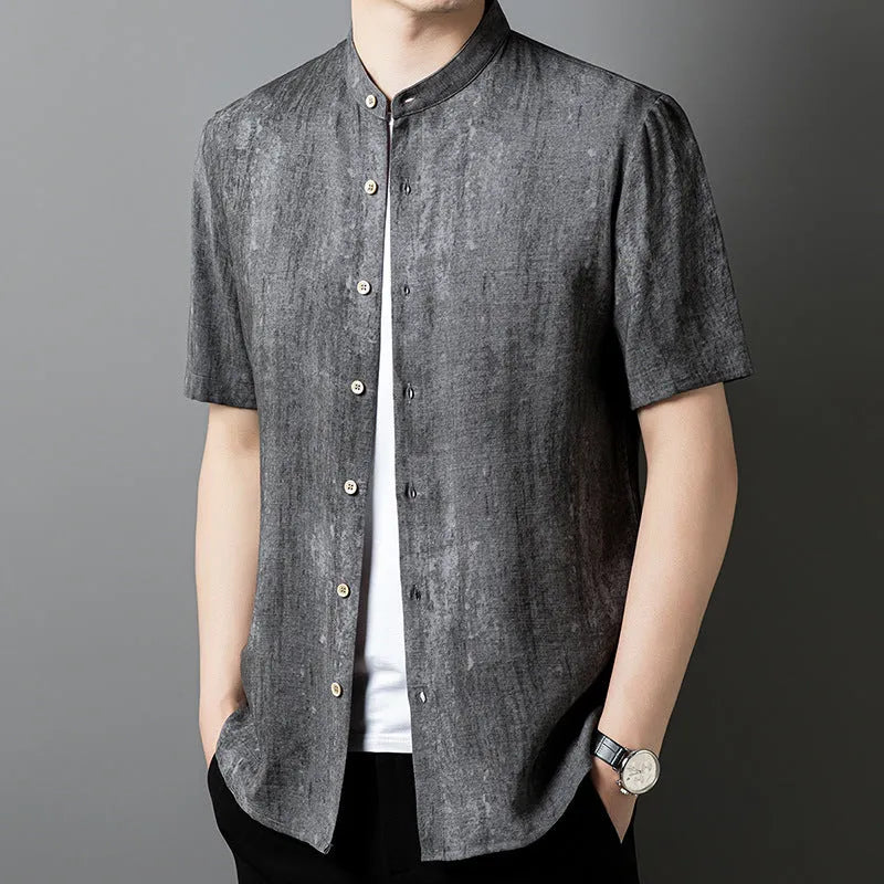 Man wearing a grey loose-fit linen blend cardigan shirt with a stand collar.