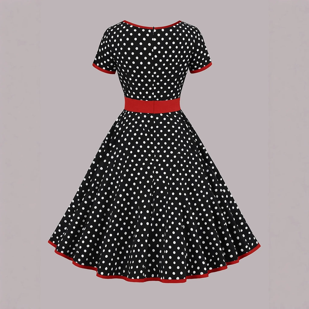 Women's multicolour polka dot dress with a square collar, short sleeves, and a pleated mid-length skirt.