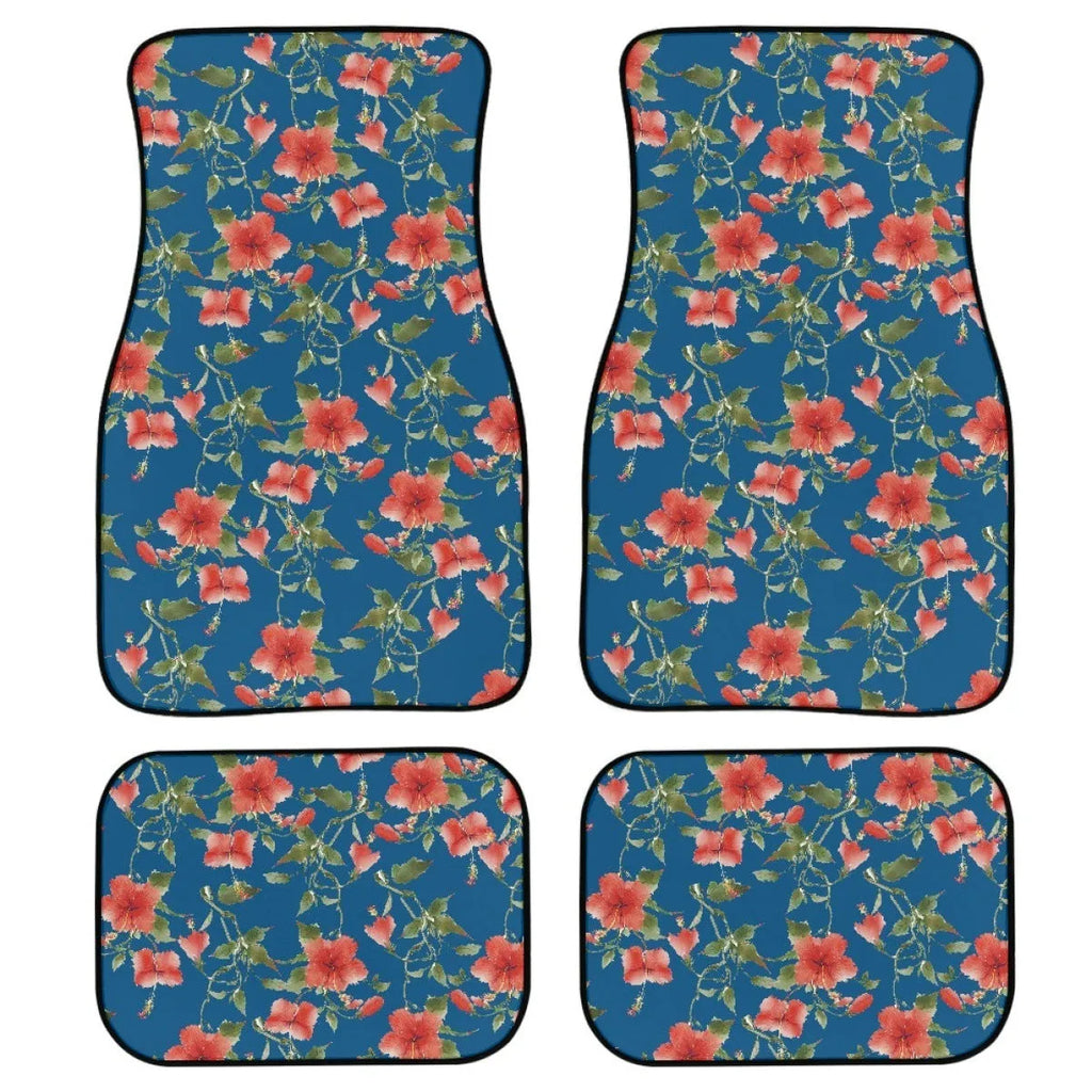 Set of four black rubber car floor mats with a textured surface, shown in a vehicle footwell.