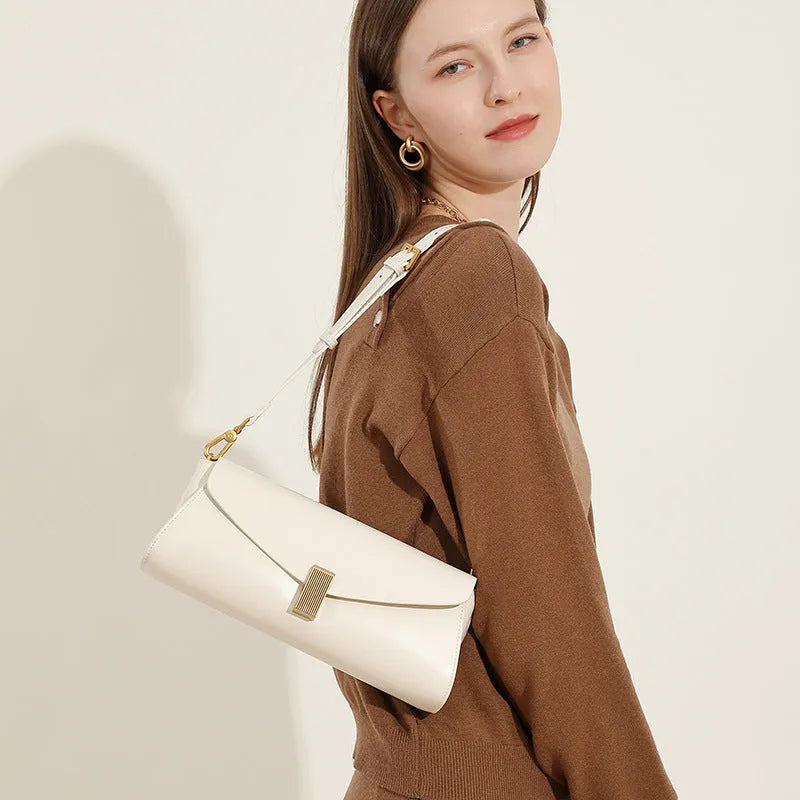 Women's leather cross-body bag with clamshell design and pillow shape in multiple colours