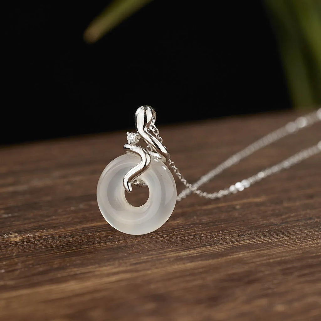 Women's sterling silver snake necklace with white jade inlay pendant on cross chain