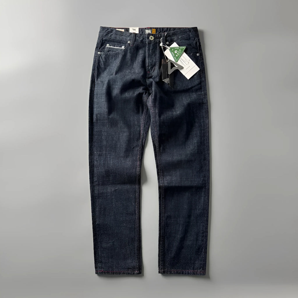 Man wearing blue straight leg denim jeans with a mid waist, showcasing the classic five-pocket retro design.