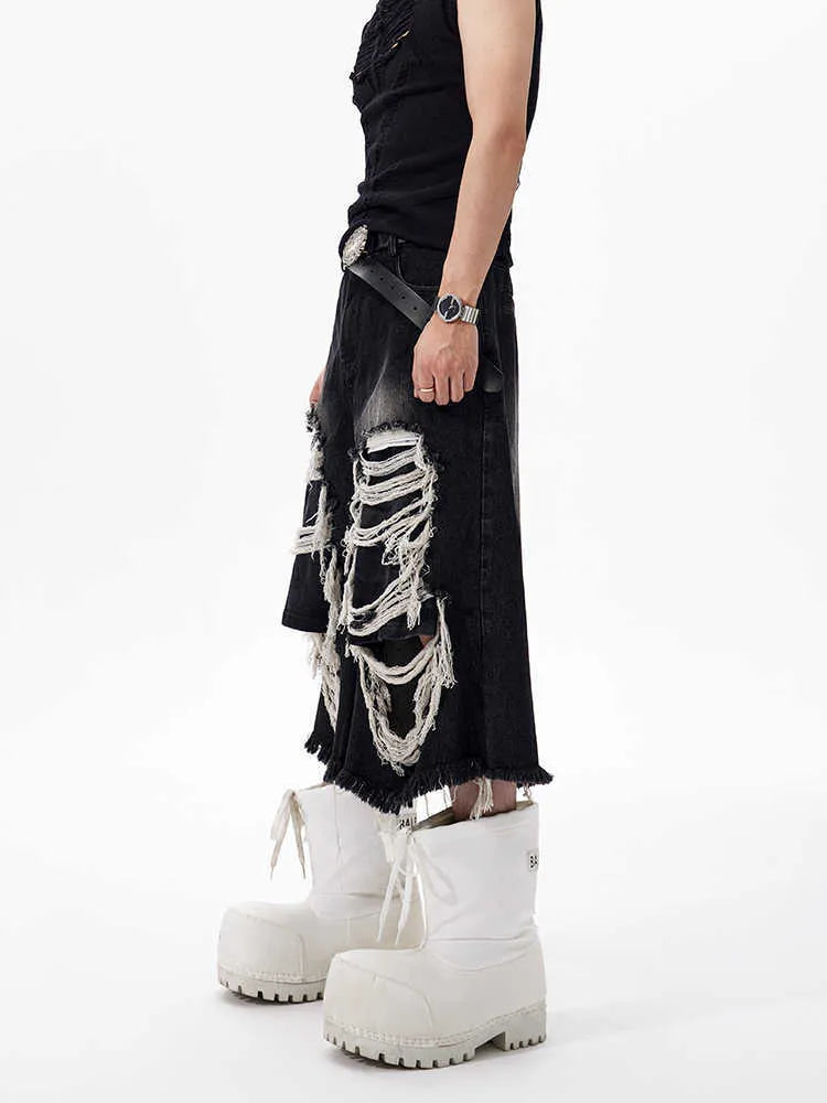 Black wide leg cropped jeans with distressed patch details on the legs, showing a mid-high waist.