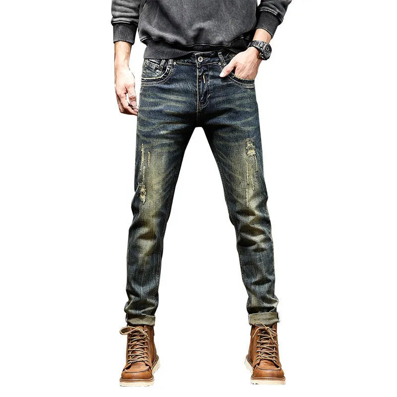 Men's skinny fit jeans in a retro blue wash with a zip fly, shown laid flat.
