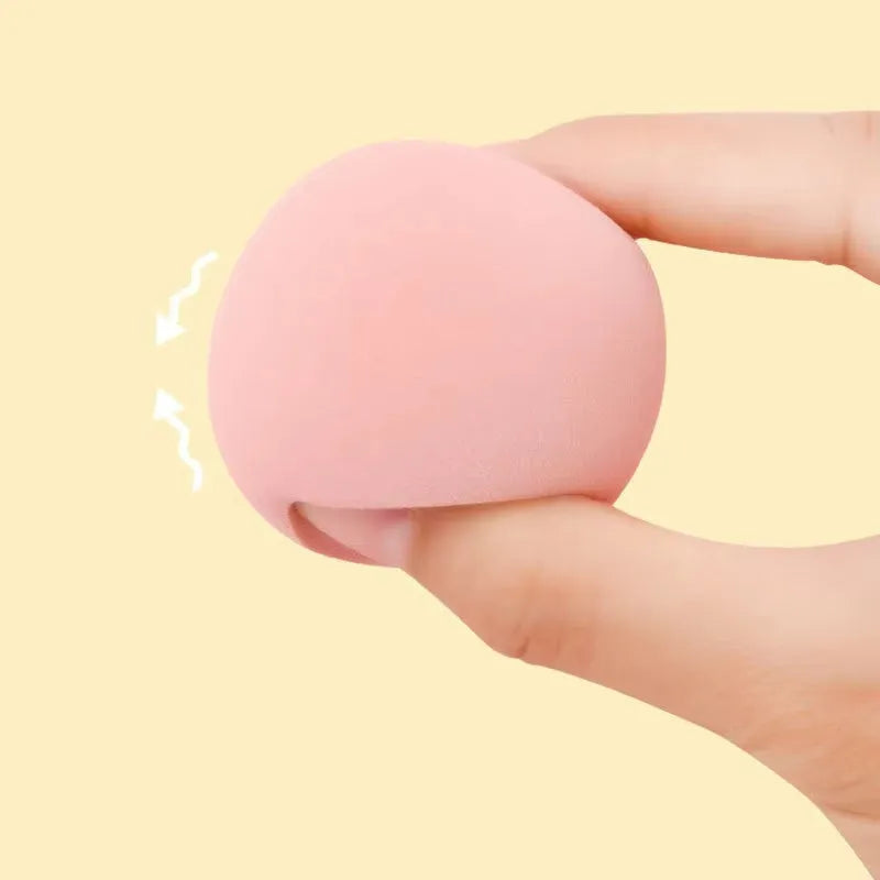 Seven different shaped makeup sponge puffs in various colours including pink, blue and burgundy