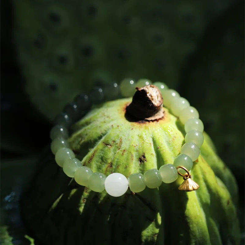 Green Hetian jade bracelet with vintage ethnic style beads on a string.