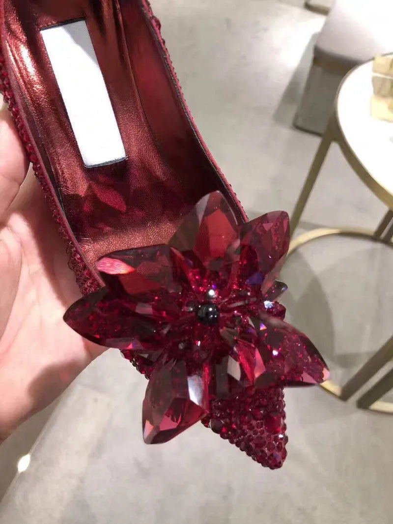 Women's gold high heels with pointed toe, rhinestone decoration, and a stiletto heel.