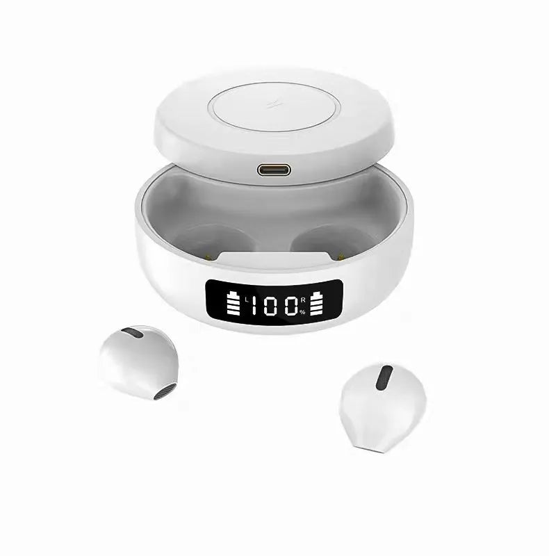 Black wireless semi-in-ear headphones next to their white charging case on a table.