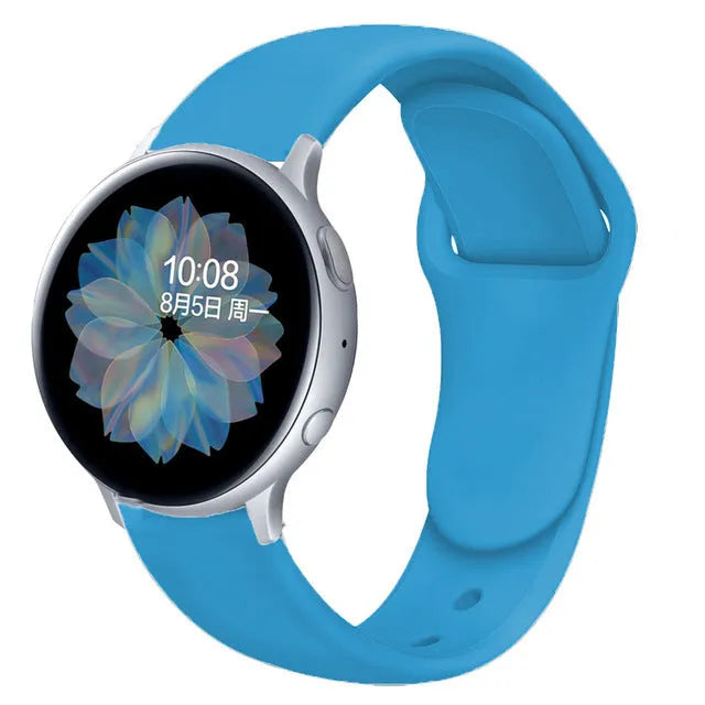 Samsung Galaxy Active 2 watch with a purple reverse buckle silicone strap on a wrist.