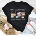 Black loose-fit cotton t-shirt with short sleeves and a round neck on a hanger.