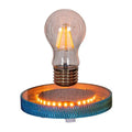 Small magnetic suspension moon night lamp with 3D-printed design on a shelf.