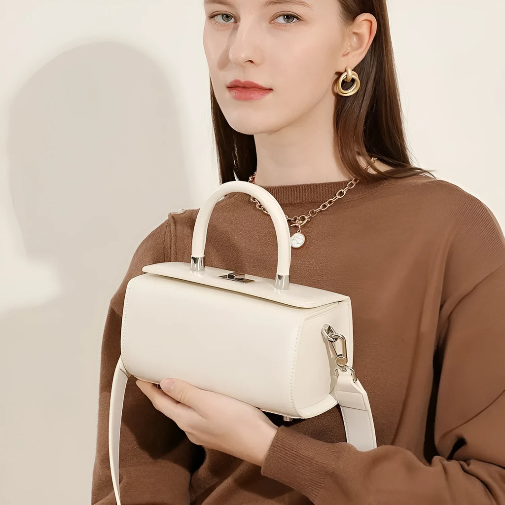 Women's cowhide leather crossbody bag in clamshell design with single shoulder strap