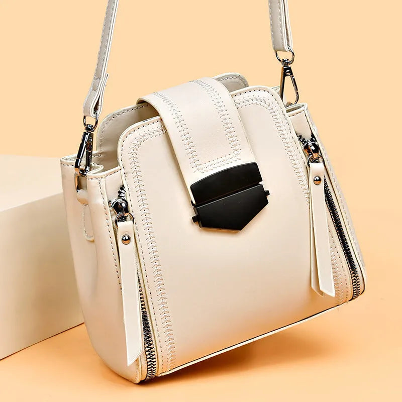 Small square vertical ladies handbag in soft textured PU leather, showing sewing thread detail.