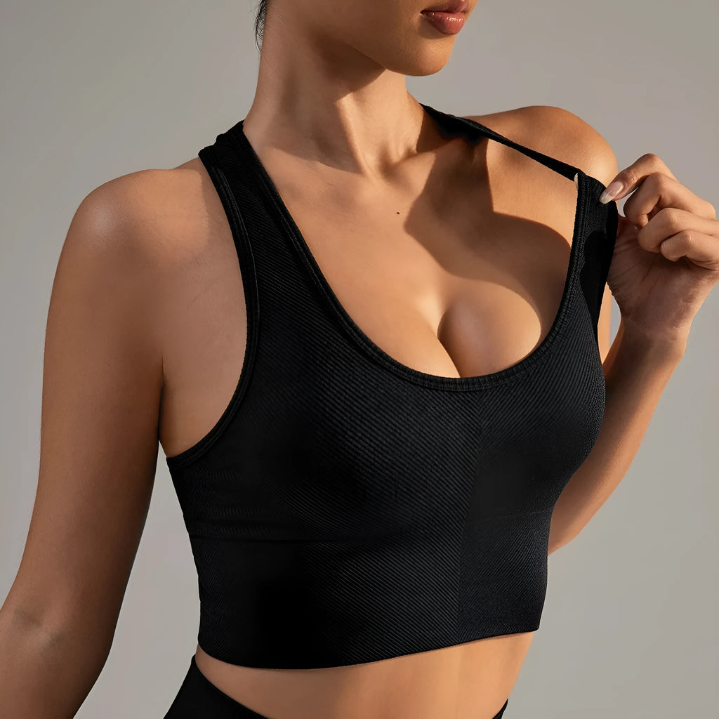 Black women's sports bra with cross-back design and moulded cups for yoga and running.