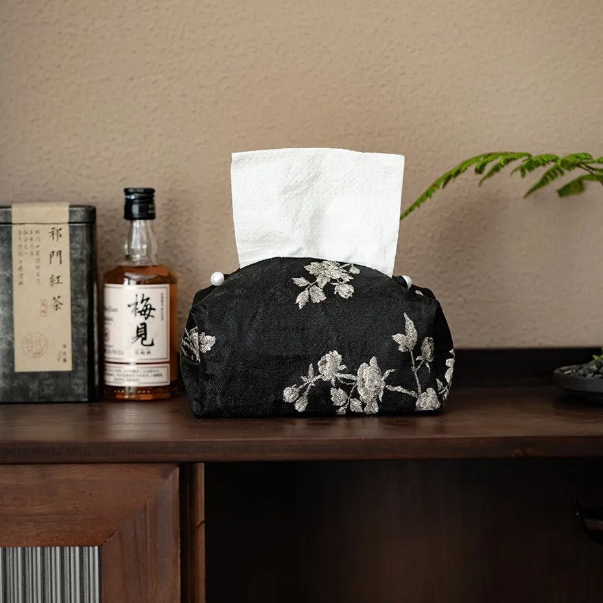 White Chinese brocade tissue box cover with embroidered plum blossoms, showing pearl buckle and plain opening options.