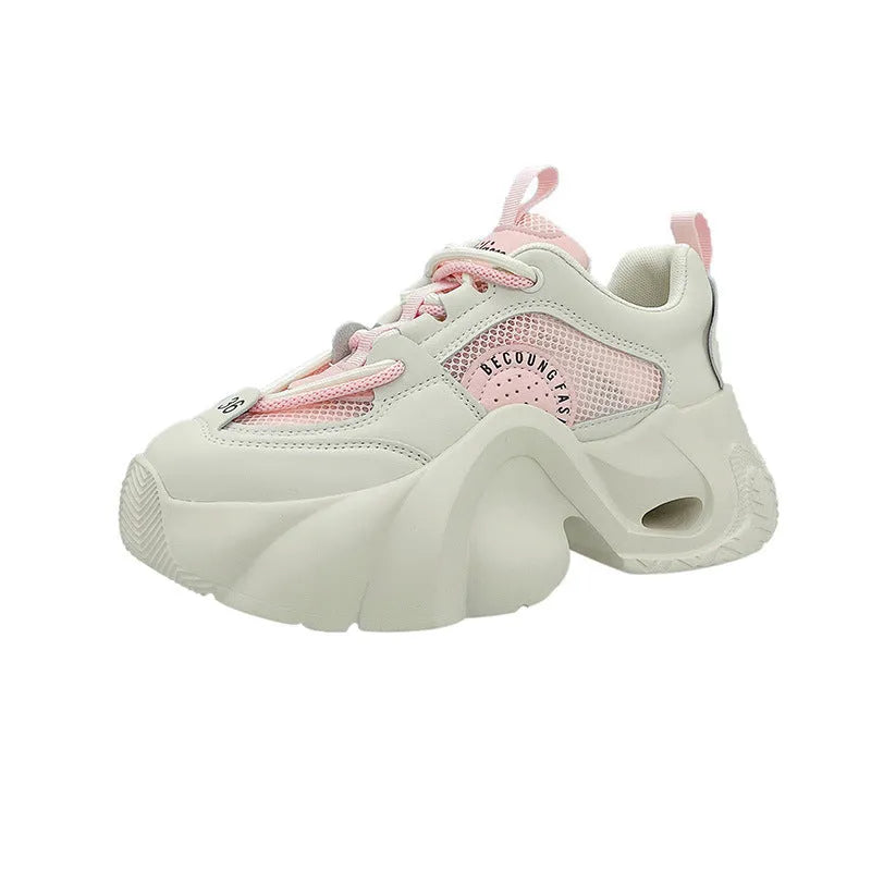 Women's pink casual sneakers with a thick sole, cross-strap detail, and lace-up closure on a white background.
