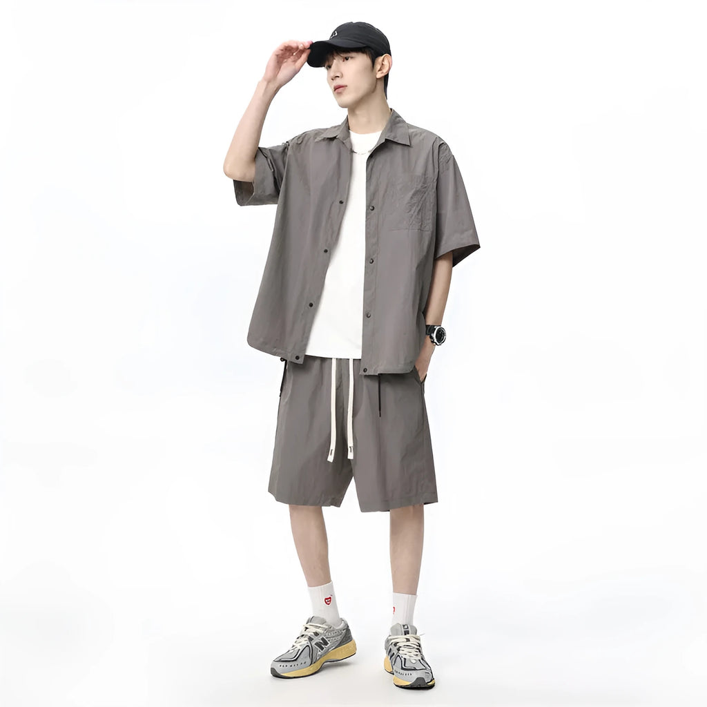 Men's loose casual shirt and matching shorts two-piece set in a light grey colour.
