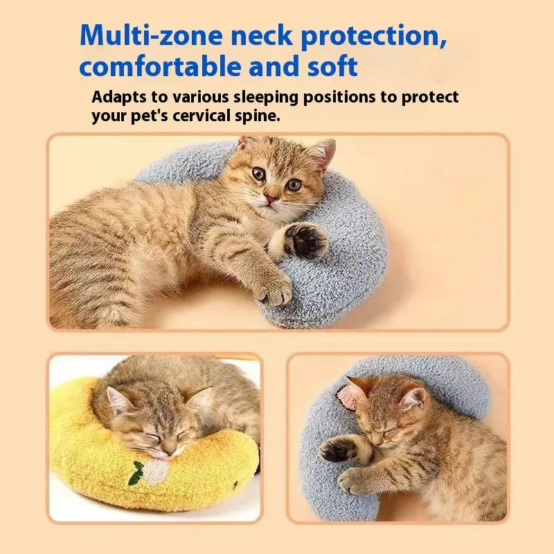 Blue U-shaped cloth pet pillow in a question mark shape on a wooden floor next to a cat carrier.
