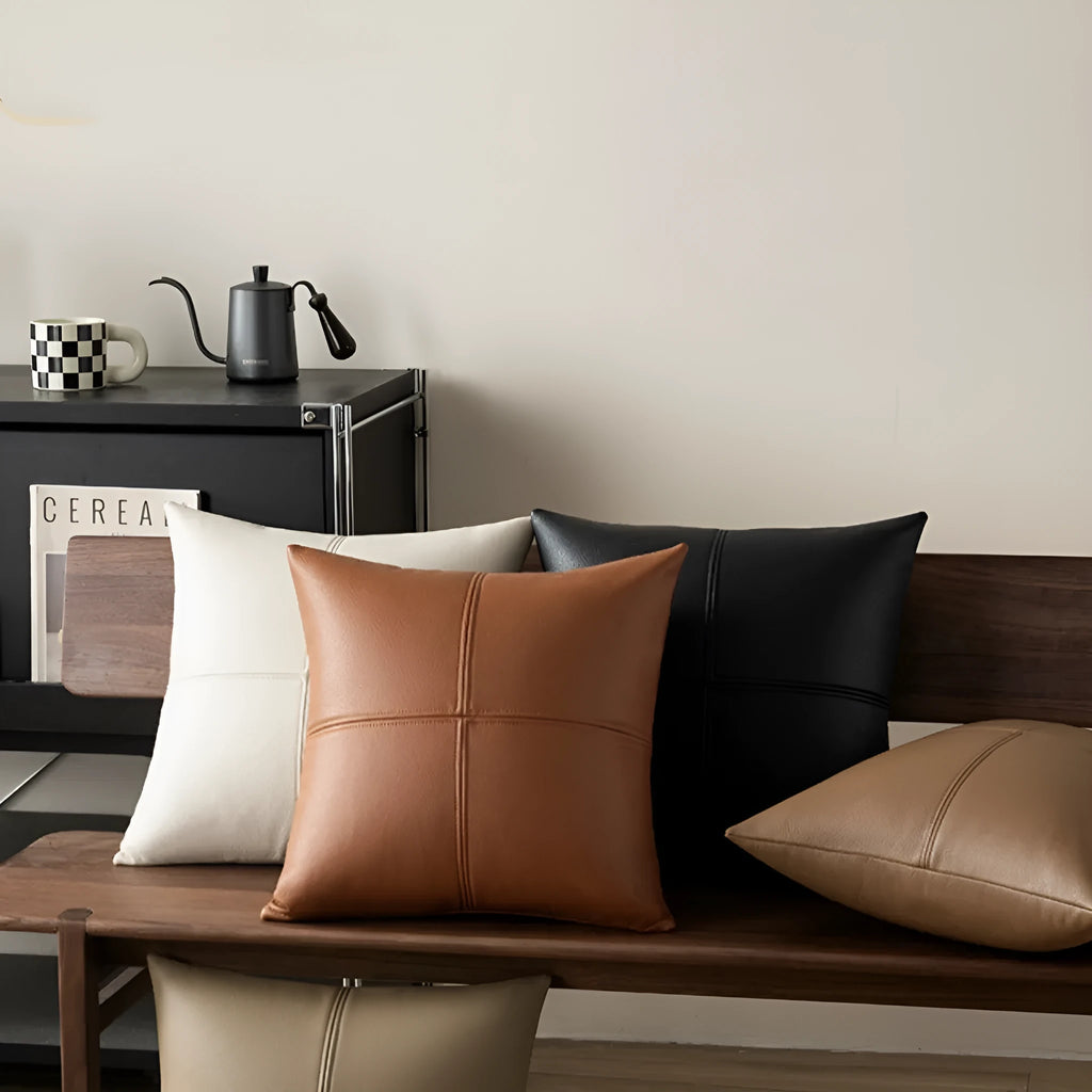 Soft cowhide leather pillow cover in a solid colour, shown in a square shape on a sofa.