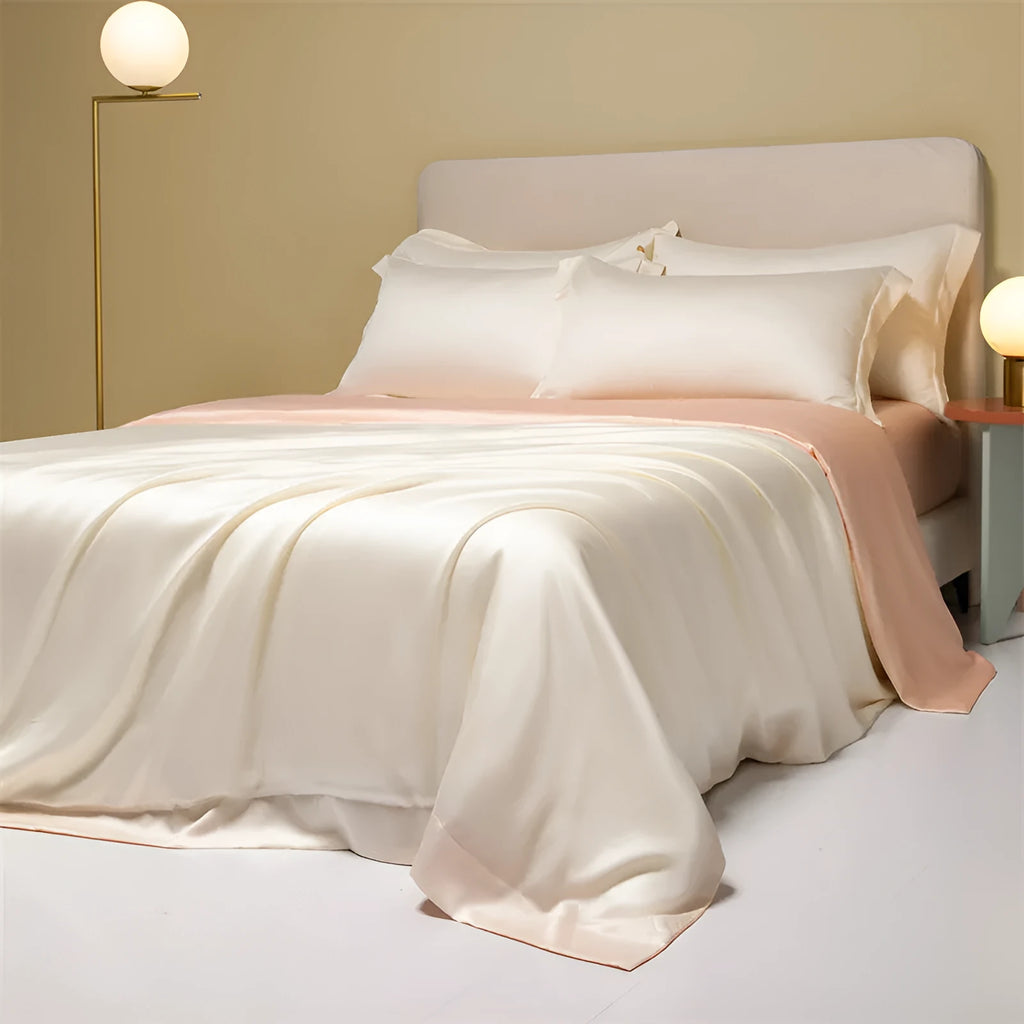 A neatly made bed with a Lenzing Tencel duvet cover and pillowcases in a soft grey colour.