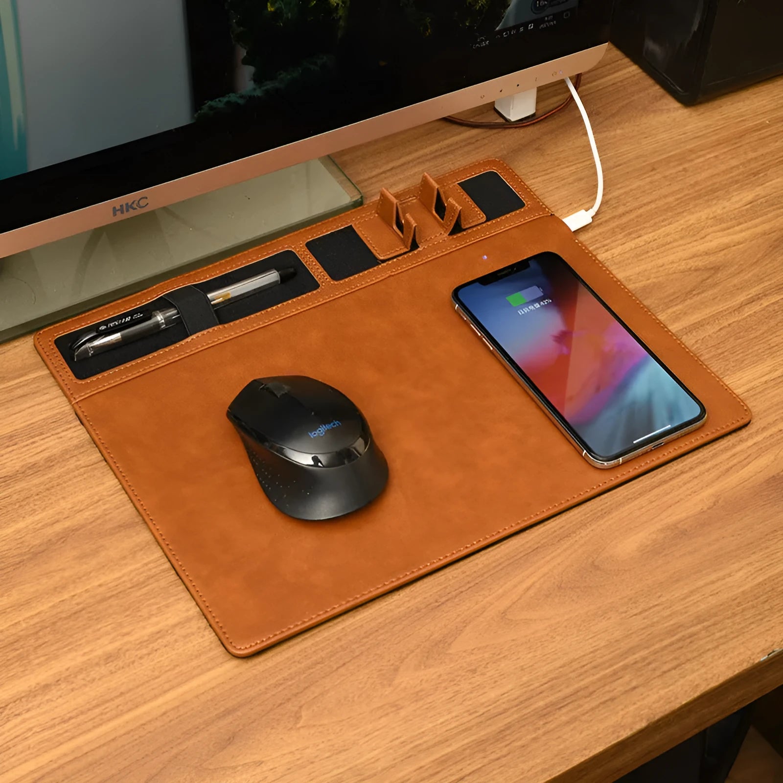 Pink PU leather mouse pad with wireless charging spot and an upright phone in the holder
