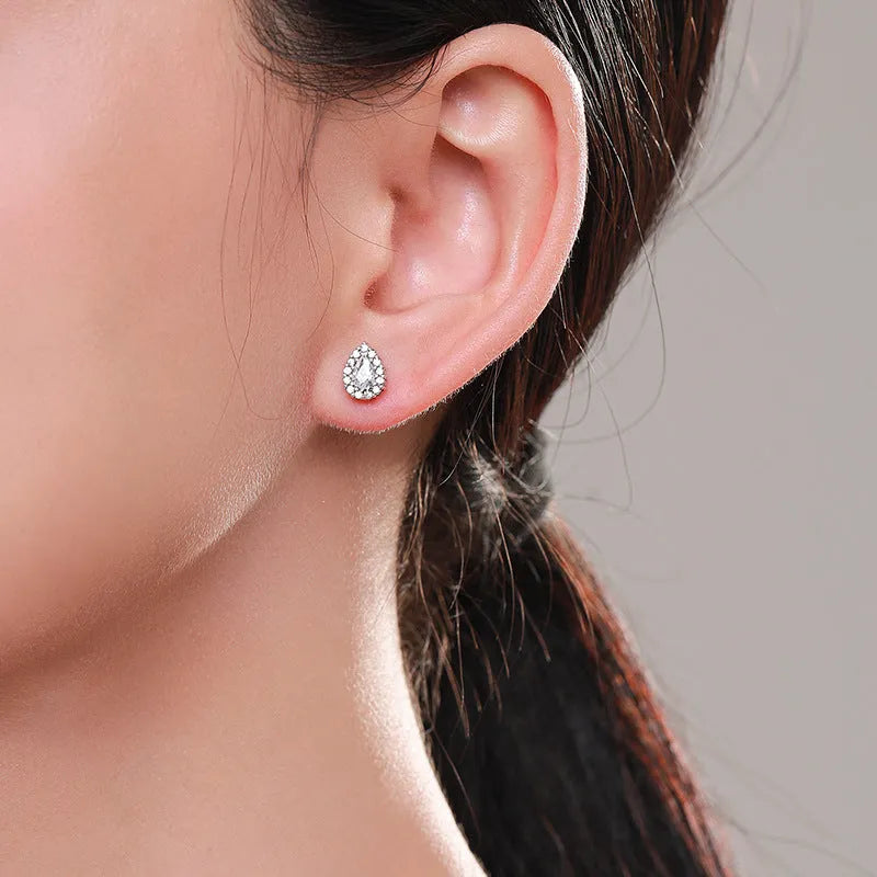 Close-up of a women's sterling silver drop ear stud with a polished finish and diamond-treated detail.