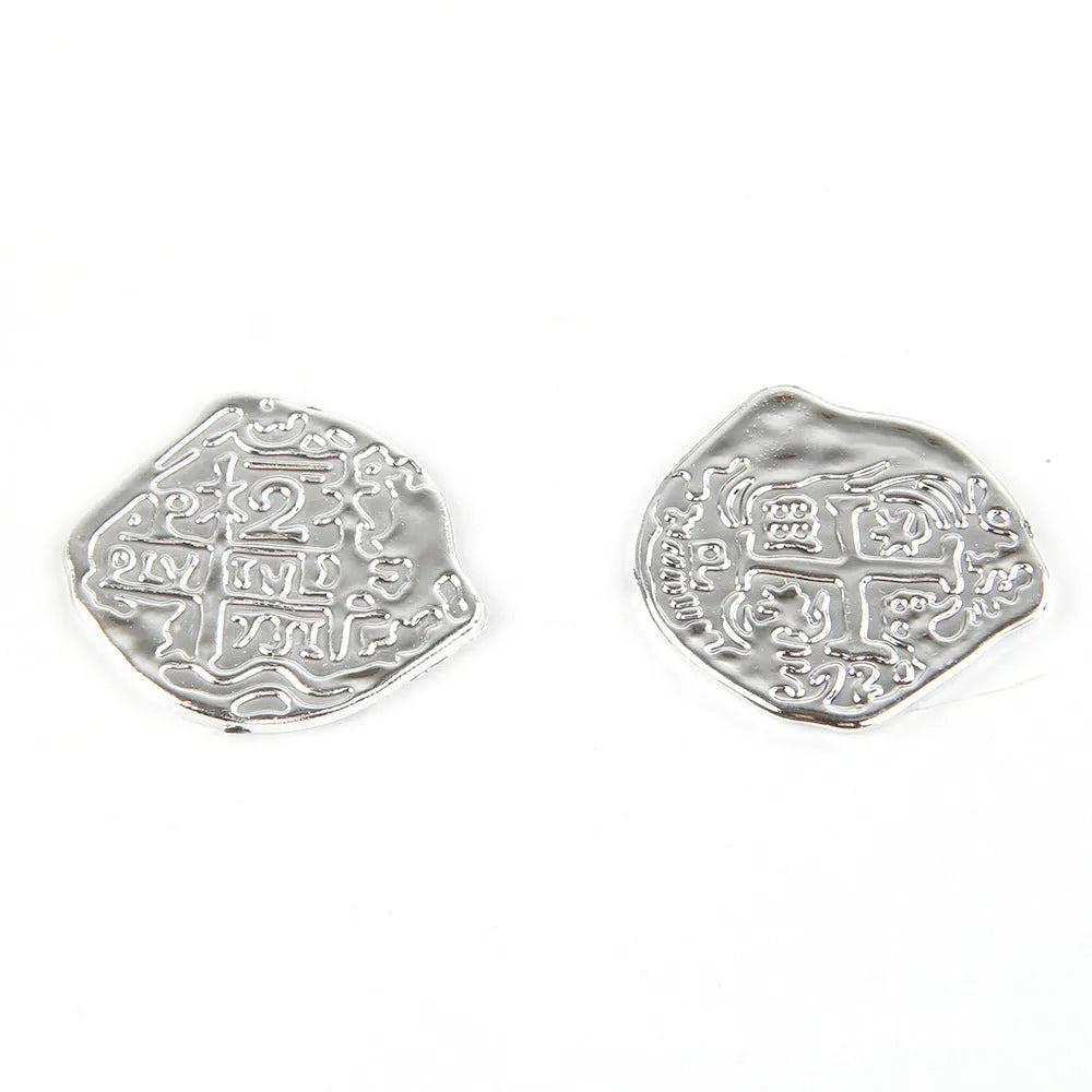 A pile of metallic gold plastic Roman pirate coins from a 100-piece pack for treasure games.