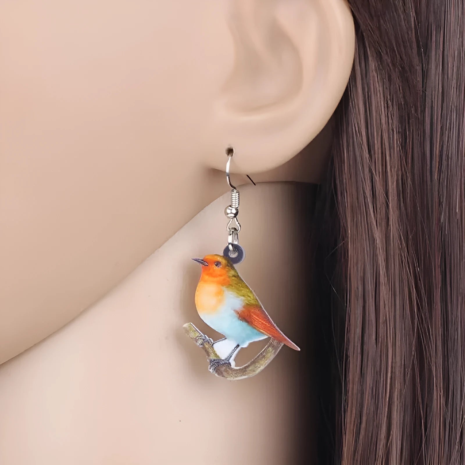 Blue, yellow, and white titmouse bird acrylic pendant drop earrings on a white background.