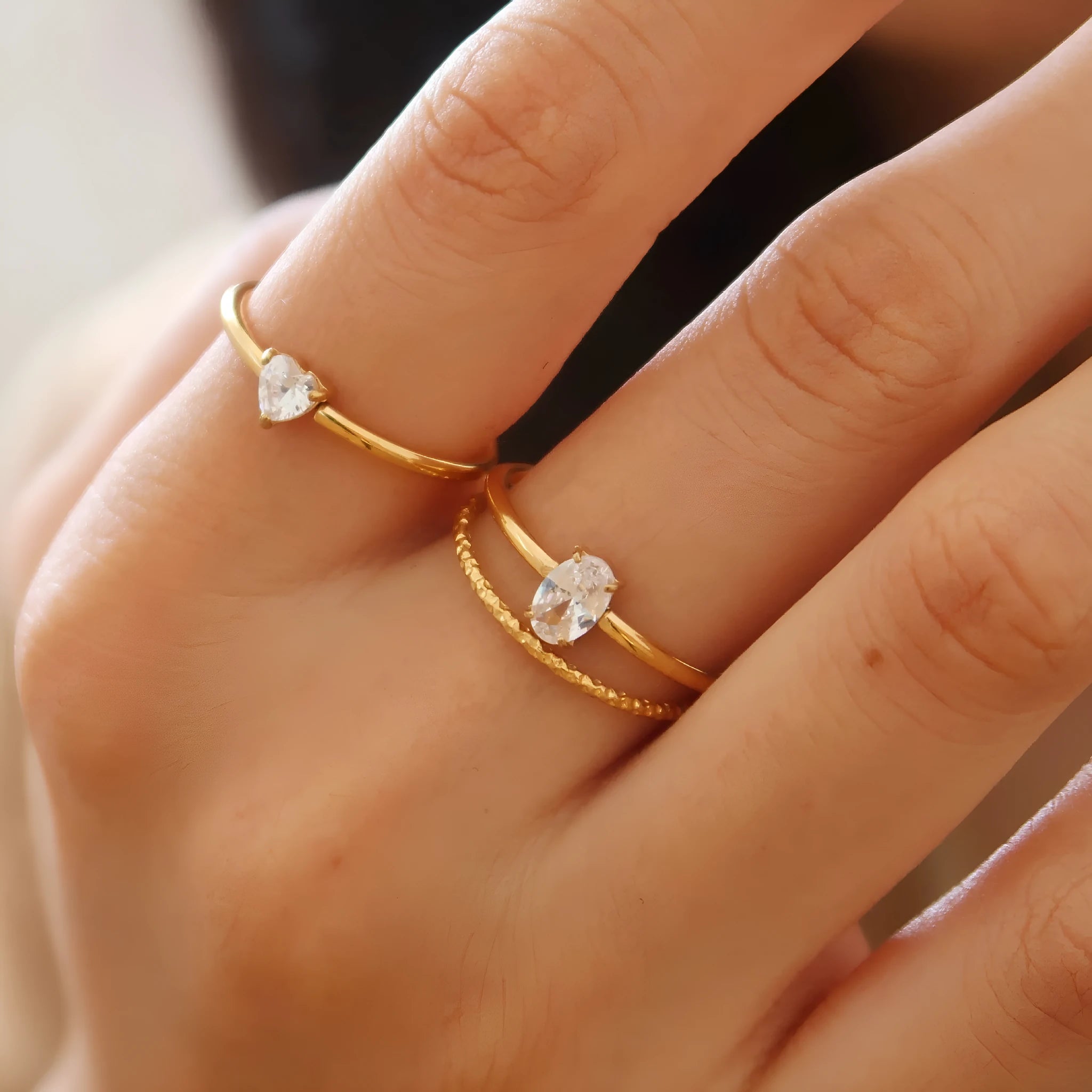 Golden stainless steel love heart ring with an oval ring bath design.