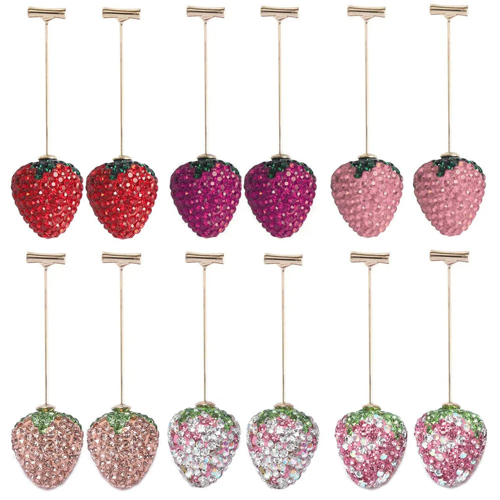 Geometric strawberry shaped zinc alloy earrings with spot drill texture on a red background.