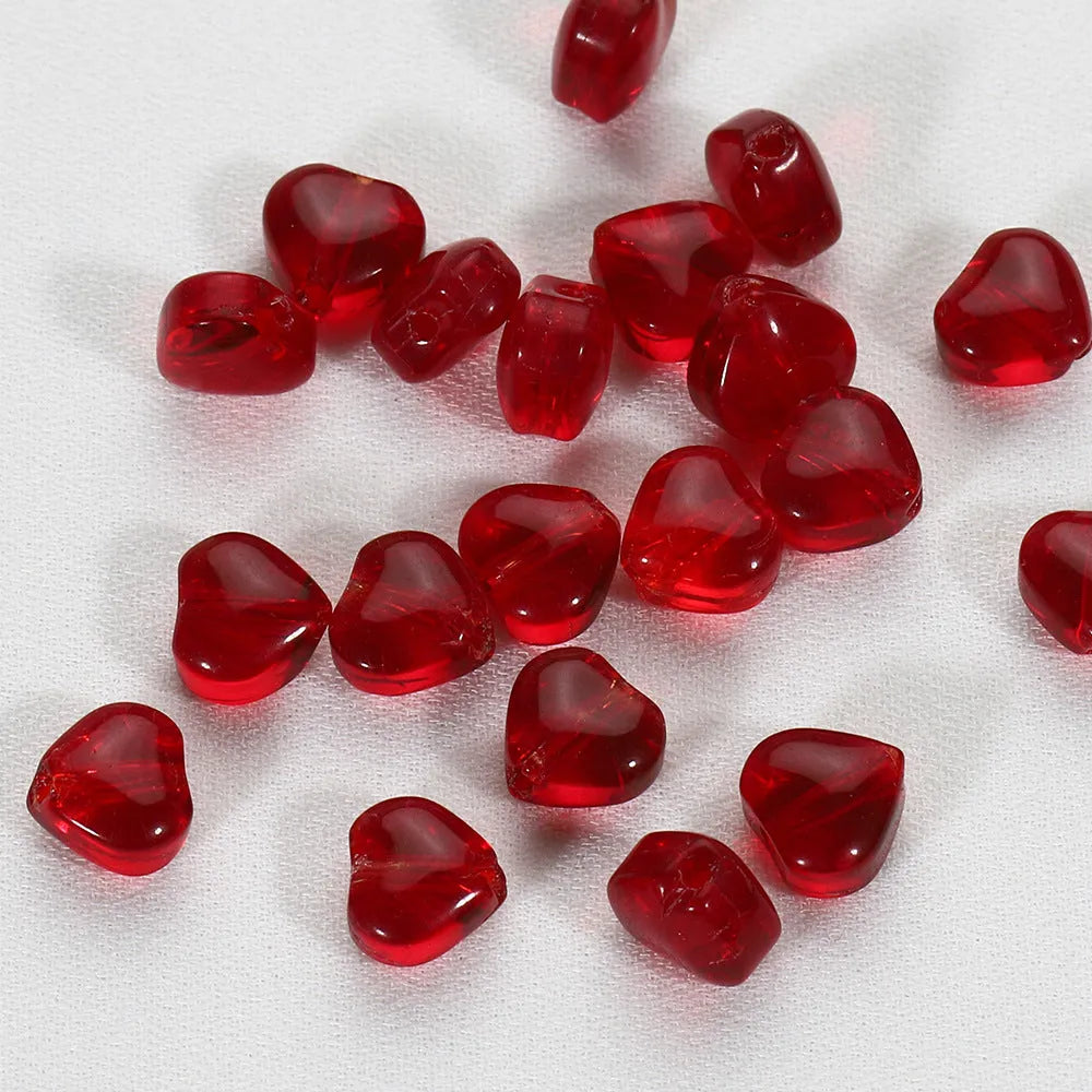 Twenty transparent Czech glass love heart spacer beads in assorted colours including aurora purple and peach gold.