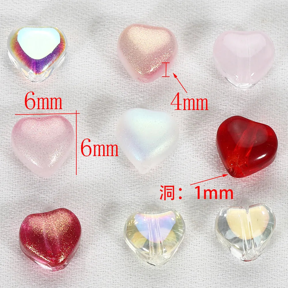 Twenty transparent Czech glass love heart spacer beads in assorted colours including aurora purple and peach gold.