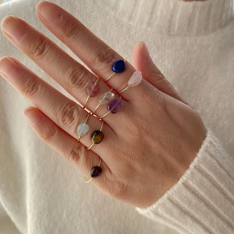 Women's geometric niche design ring with a coloured agate stone centrepiece.