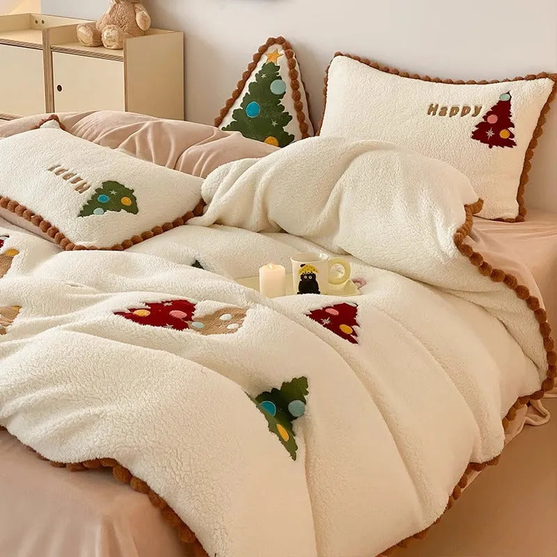 Bright yellow and white Christmas tree fleece bedding set with embroidery on a bed.