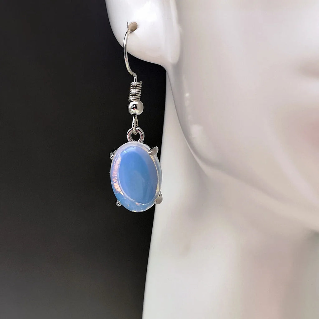 A pair of retro-style drop earrings with a moonlight opal centre on an electroplated alloy setting.