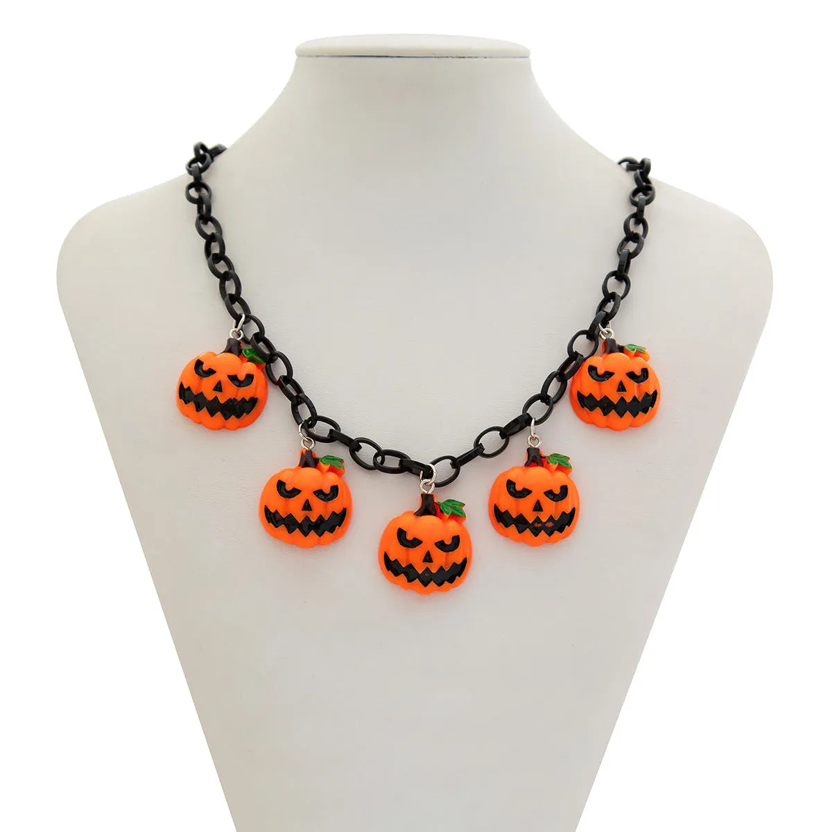 Halloween necklace showing a cartoon ghost and pumpkin acrylic pendant on a chain, colour 06705.