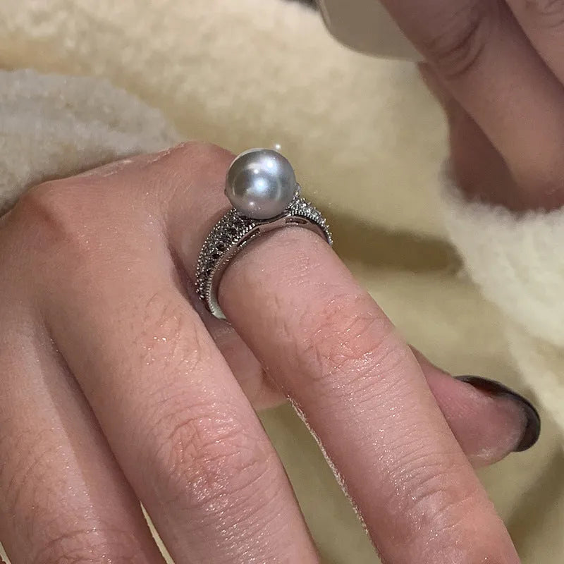Adjustable open-ended copper ring for women in a geometric shape on a finger.