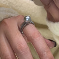 Adjustable open-ended copper ring for women in a geometric shape on a finger.