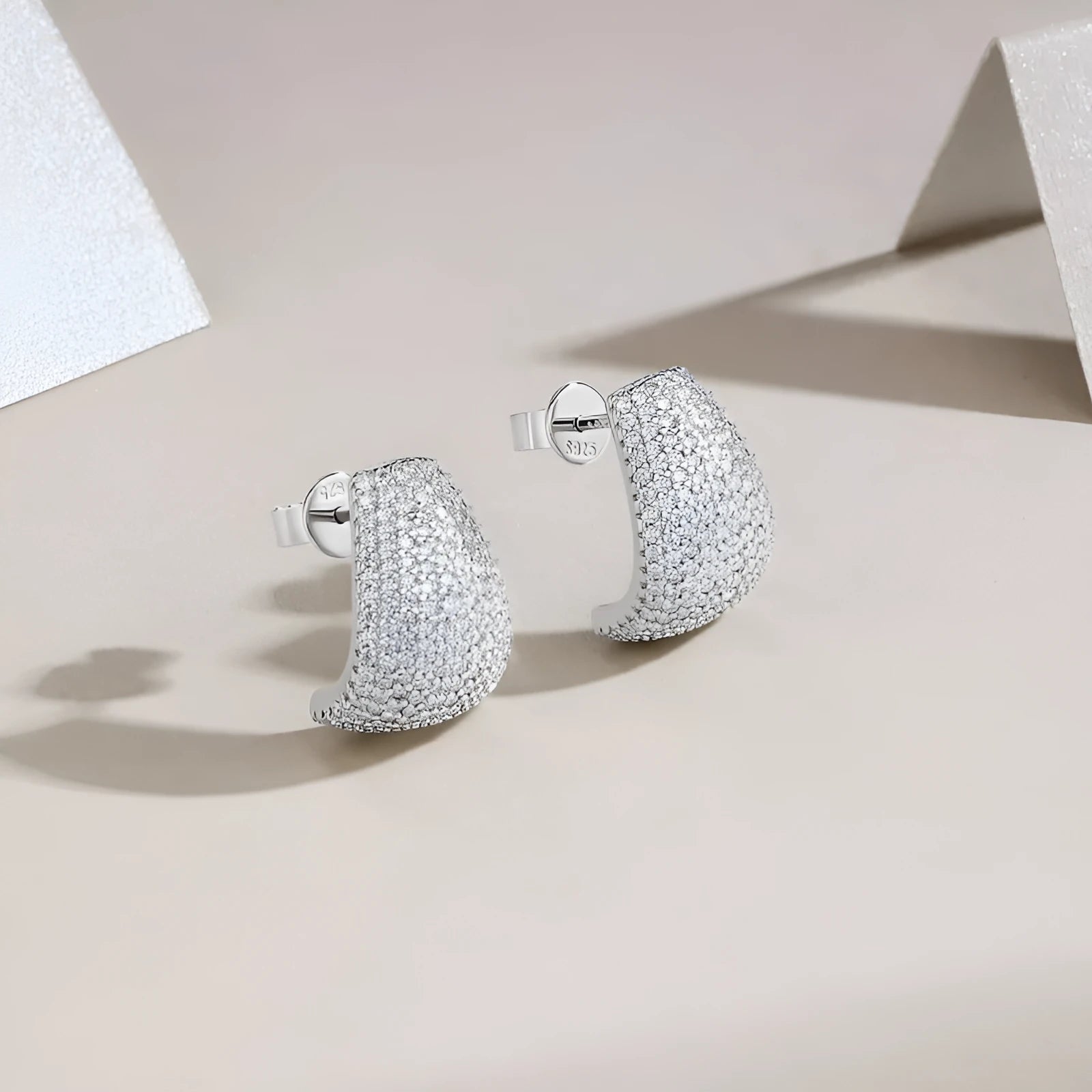 Geometric sterling silver stud earrings with a d-e colour moissanite stone.